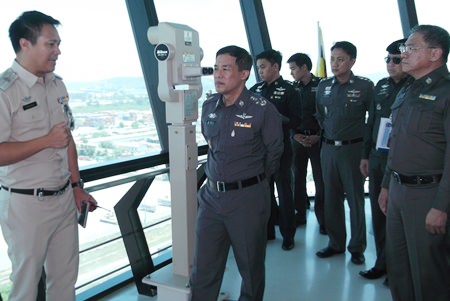 Royal Thai Police Deputy Commissioner-General Pol. Gen. Wuthi Liptapanlop (center) inspects surveillance equipment on top of a 20-story tower overlooking the entire port area.