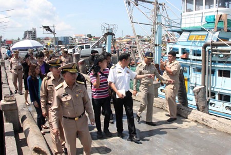 Top Navy officers and port officials inspect fishing boats in harbor at Sattahip.
