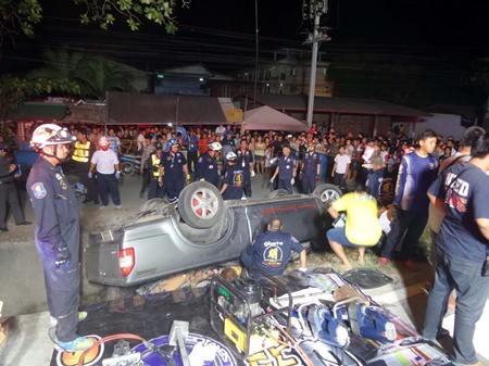 Emergency technicians work to free the bodies of Pvt. Prommin Pommeungkwa and his wife Anongsri from the wreckage.