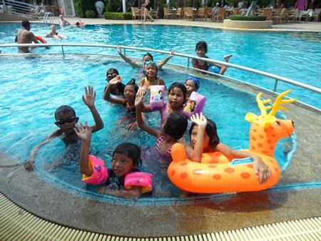 The children enjoy playing in the big pool.