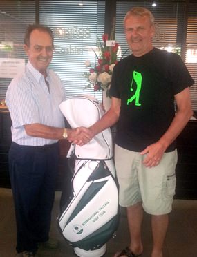 Jim Underwood (right) receives his IPGC hole in one prize golf bag from Stephen Beard.
