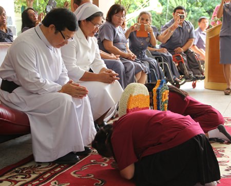 The students bow low to show their respect.