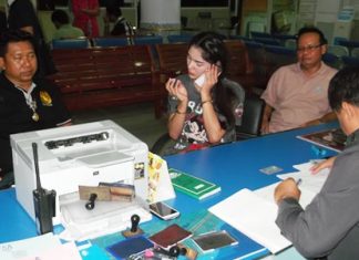 Nawin Maunsaiyad (center, on phone) has been arrested and charged with theft.