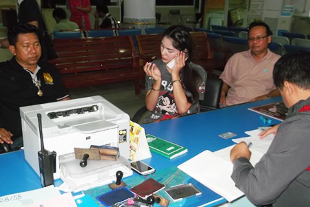 Nawin Maunsaiyad (center, on phone) has been arrested and charged with theft.