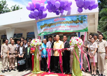Chonburi Gov. Khomsan Ekachai (center) leads officials in cutting the ribbon to officially open the new Samae San Migrant Children’s Center.