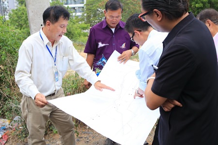 Officials study a land survey in order to plan new sidewalks, public areas and road resurfacing around Bali Hai Pier to ease traffic and parking problems.