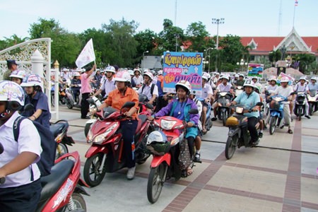 Participants in the project don helmets and ride off after the speeches concluded.