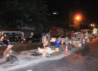 City workers repair bumpy Second Road City workers repair the drain covers on Pattaya Second Road.