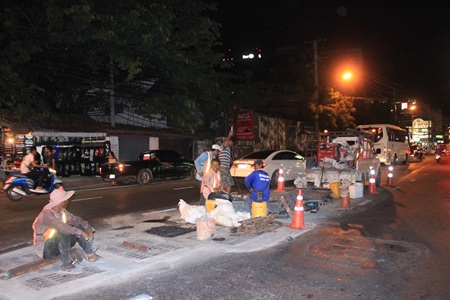 City workers repair the drain covers on Pattaya Second Road.
