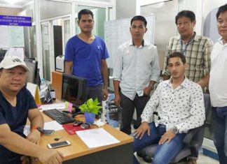 Anas Saleem Ali Alsharab (seated, right) has been arrested for trying to extend a fake visa in his fake passport.