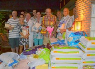 Chris Gibbins (with flowers) celebrates his 77th birthday with friends.