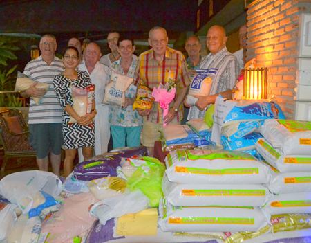Chris Gibbins (with flowers) celebrates his 77th birthday with friends.