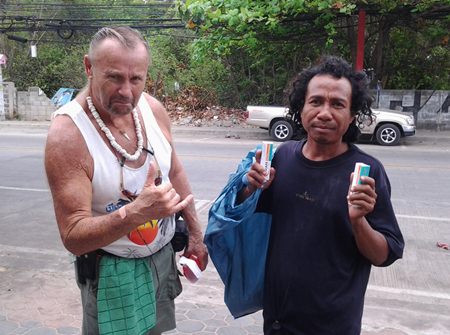 Gerry helps out a homeless Thai man.