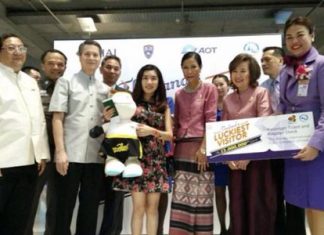 Vu Minh Phuong (center, holding stuffed doll) became the 13-millionth tourist visiting Thailand this year.