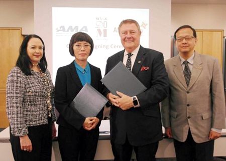 Wilai Somdungjate-Ottevaere (2nd left), Chief Marketing Officer of MQDC and Edward T. Reilly (3rd left), President and CEO of AMA (American Management Association) pose for a photo in New York after signing off on the new training scheme.