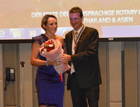 Eric Larbouillatt president of the Rotary Club Pattaya Marina presents a bouquet to Madame Maria, wife of the French consul.