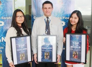 GIS Principal Dr Stuart Tasker presents Sarah (left) and Yeen (right) with their posters. Sarah is going to study at UCLA, whilst Yeen will be going to study at Durham University.