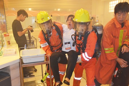 Mall firefighters practice evacuating an injured woman during a simulated fire emergency at Central Festival Pattaya Beach.