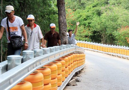Pedestrians enjoy the extra protection the new barriers give them along the twisting road up Pratamnak Hill.