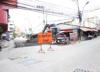 K-Sky Engineering workers begin digging up Soi Sophon Market to resurface it.