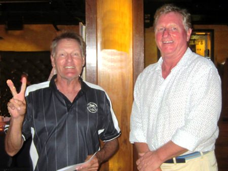 A Flight winner Steve Truelove (left) receives his prize from Maurice.