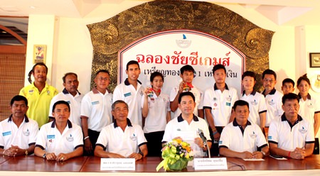 Pattaya mayor Itthiphol Kunplome (seated 3rd right) poses with Thailand’s star windsurfers and coaching staff at the Surf Kitchen in Jomtien Beach, July 2.