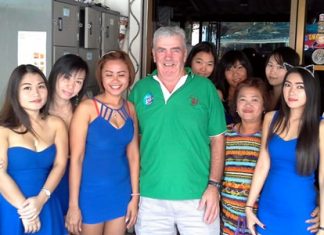 Russell (centre) celebrates his win with the staff at Blue Sky Bar.