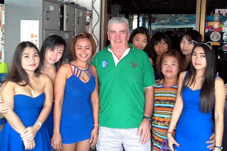 Russell (centre) celebrates his win with the staff at Blue Sky Bar.