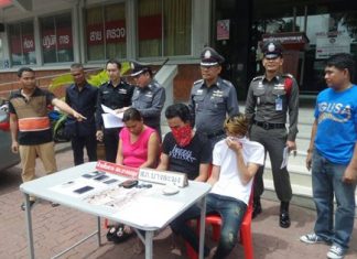 The 3 suspects, led by the apparently alluring Wallapa Puangmanee (seated left), are brought out for the press.