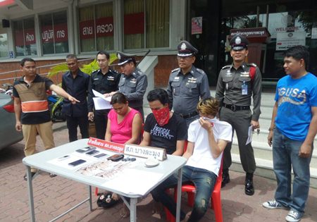 The 3 suspects, led by the apparently alluring Wallapa Puangmanee (seated left), are brought out for the press.