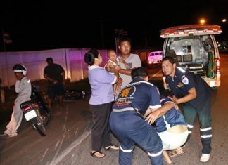The child is crying, but relatively unhurt as rescue workers help the mother into a waiting ambulance.