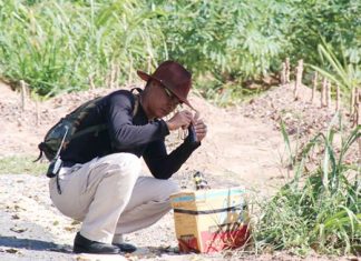 Pol. Maj. Tanamet Phopan begins his inspection of what turned out to be a fake bomb.