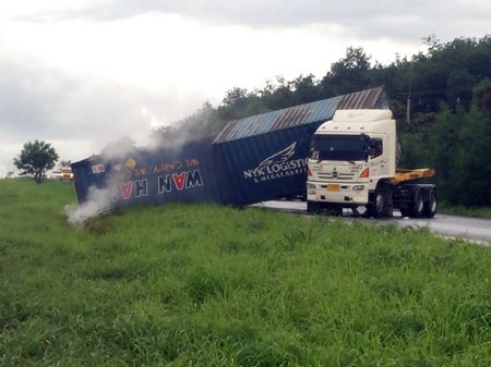 This Hino Motors truck, with a load of hydrogen peroxide, overturned on the rain-slicked highway, spilling some of the hydrogen peroxide on board which mixed with rain water creating a weak acid solution.
