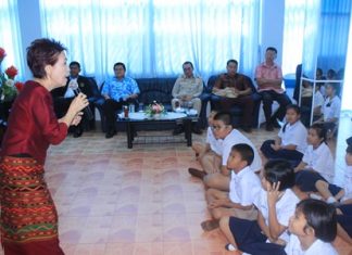 Children listen intently as Ratima Udomsiri tells magic fairy tales and fables to reinforce good behavior.