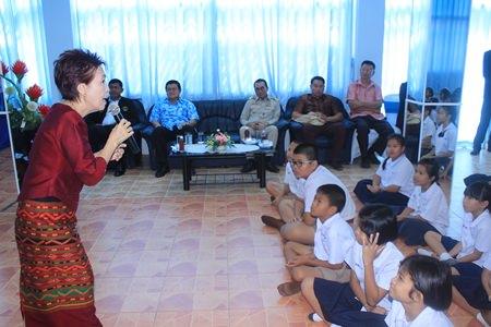 Children listen intently as Ratima Udomsiri tells magic fairy tales and fables to reinforce good behavior.