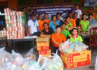 Members of Lions Club International District 310 C prepare to pack over 1,000 bags of rice and dried food to help flood victims in Tabma, Rayong.