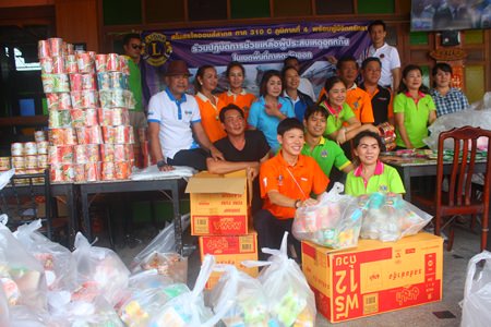 Members of Lions Club International District 310 C prepare to pack over 1,000 bags of rice and dried food to help flood victims in Tabma, Rayong.