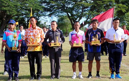 Navy team captains hold up their trophies during the closing ceremony of the Sattahip Naval Station’s internal sports competition, August 19.