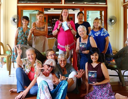 Pattaya Book Group members pose with copies of Daniel M Dorothy’s “Mango Rains’ at their monthly meeting on September 29.