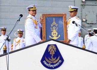 Retiring commander, Adm. Pijan Teeranet (left) passes over the command flag to successor Vice Adm. Narith Prathumsuwan (right) on the deck of the HTMS Naresuan aircraft carrier.