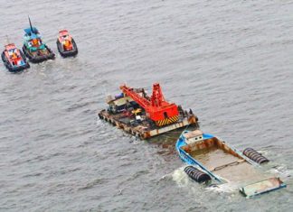 Tugboats begin towing the sunken vessel to a dockyard in Muang District of Samut Prakan.