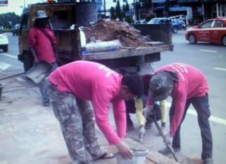 Maintenance Department staffers fix and replace tiles that were affected by the heavy floods last month.