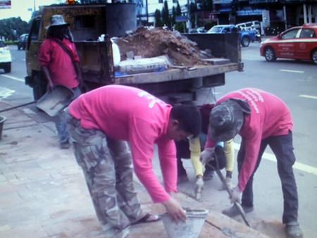 Maintenance Department staffers fix and replace tiles that were affected by the heavy floods last month.