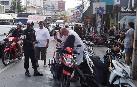 Police set up a checkpoint at the busy intersection of Second and South roads, checking for helmet use, licenses, and vehicle registrations, as well as for drugs or weapons.