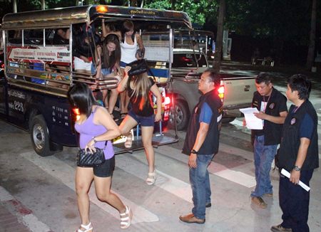 Alleged streetwalkers are transported en masse via baht bus to Pattaya police station.