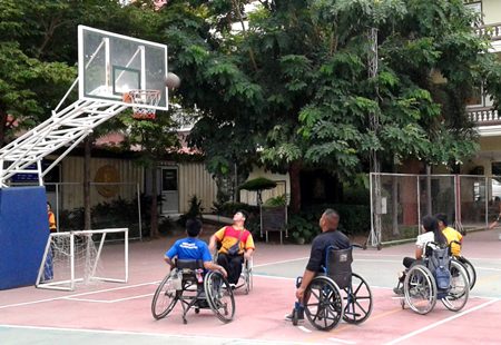 Students take part in a basketball game at the Redemptorist Vocational School in Pattaya, Friday, Oct. 2