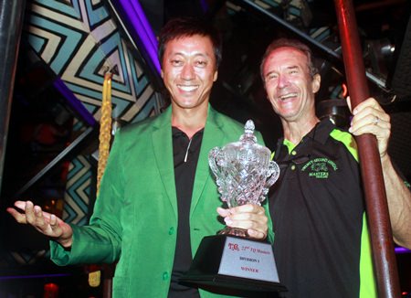 2015 TQ Masters champion Gene Connor (left) dons the green jacket as he accepts the Division 1 trophy from Lewis ‘Woody’ Underwood (right) at the Tahitian Queen rock ‘n’ roll bar on Friday, Oct. 16. For a full report on the 22nd annual TQ Masters golf tournament.