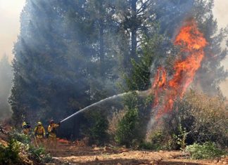 In this Sept. 17, 2014 file photo, firefighters battle the flames from the King fire near Fresh Pond, Calif. New scientific analysis shows the fingerprints of manmade climate change on 14 extreme weather events in 2014, hitting every continent but Antarctica. (AP Photo/Rich Pedroncelli, File)