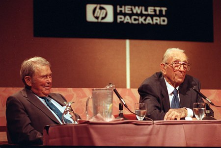 In this Sept. 17, 1993, file photo, David Packard, right, co-founder of the Silicon Valley computer company Hewlett-Packard, announces his retirement as chairman during a news conference at HP’s headquarters in Palo Alto, Calif. Packard, 81, started the company in 1939 with William R. Hewlett, who listens at left. Hewlett-Packard, one of the nation’s most storied tech companies split in two the weekend of Oct. 31, 2015, another casualty of seismic shifts in the way people use technology and big-company sluggishness in responding. (AP Photo/Joe Pugliese, File)