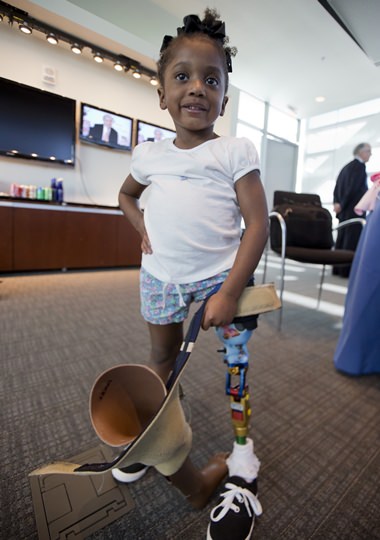 Miyah Williams, 3, holds her old prosthetic leg while showing off a new one in Washington, Friday, Oct. 23, 2015, during a meeting on the need for innovative pediatric medical devices hosted by Children’s National Health System. (AP Photo/Manuel Balce Ceneta)